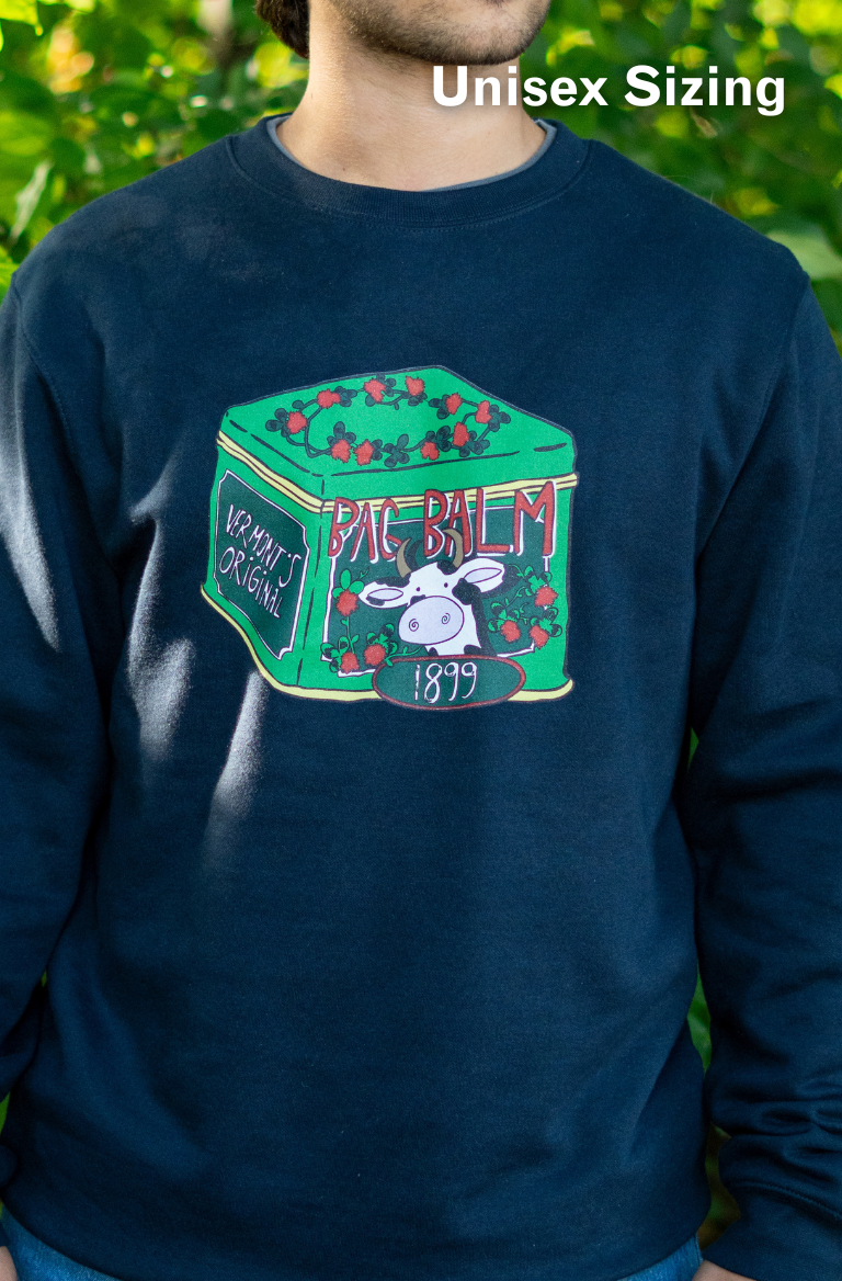 man wearing a crewneck sweatshirt with a cow + tin design