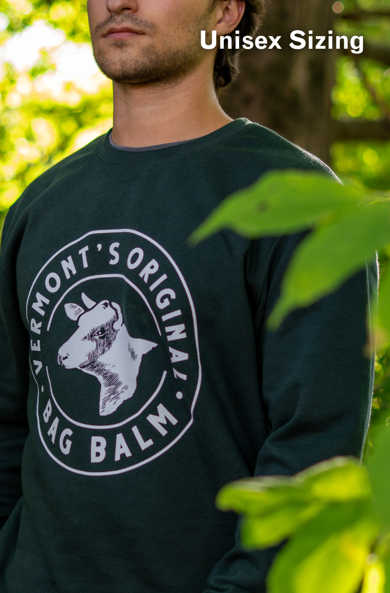 A man wearing a crewneck sweatshirt with a cow + crest design.