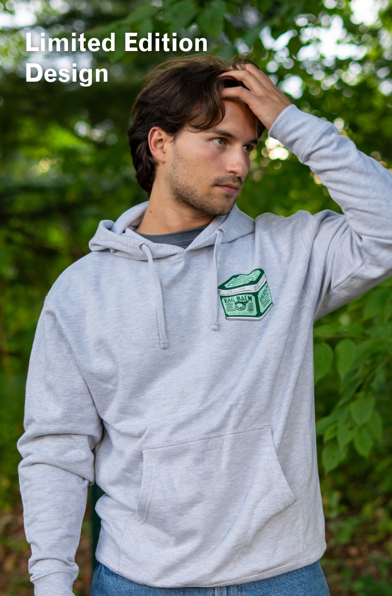 Man wearing a gray hoodie with a vintage tin design