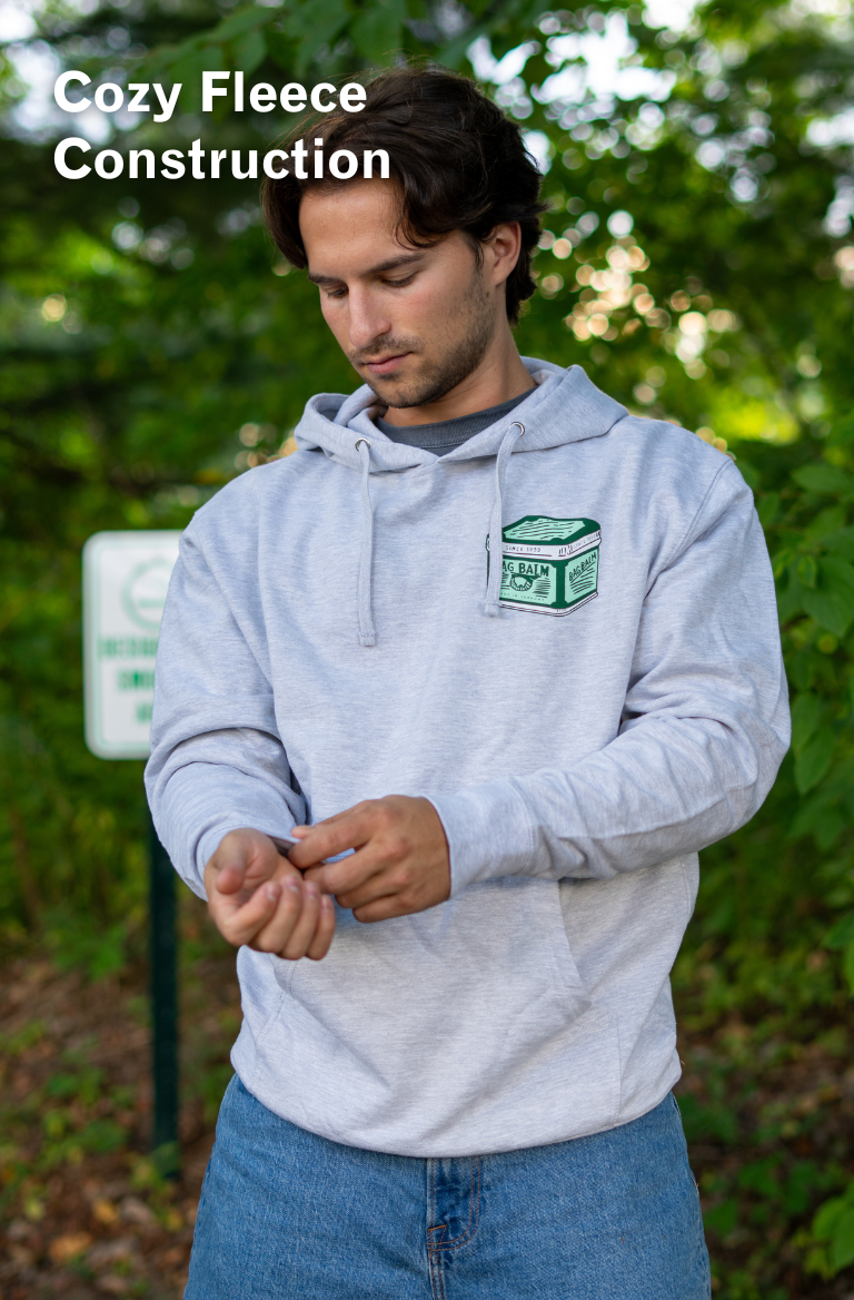Man wearing a gray hoodie with a vintage tin design
