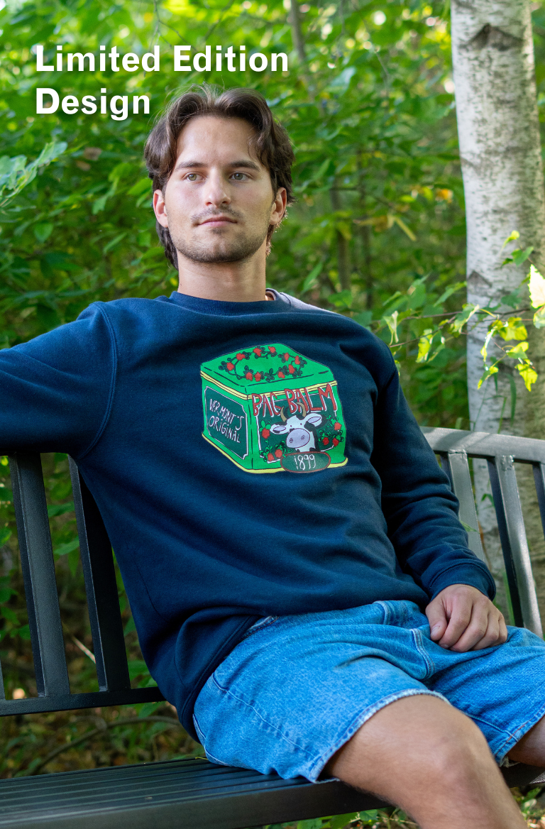 man wearing a crewneck sweatshirt with a cow + tin design