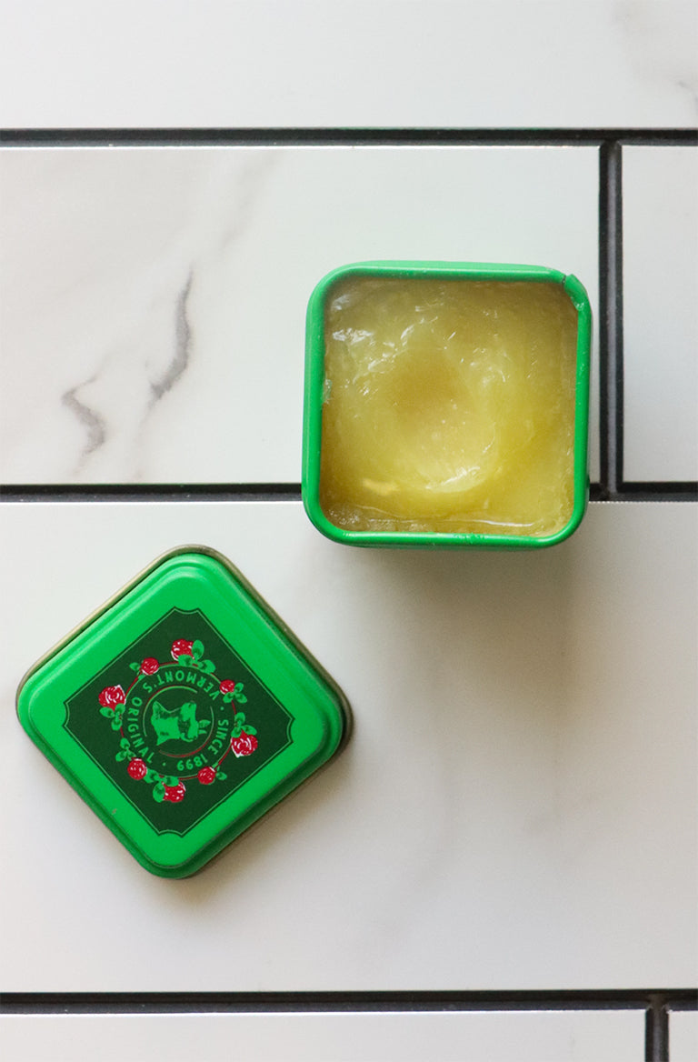 An open mini tin of Bag Balm