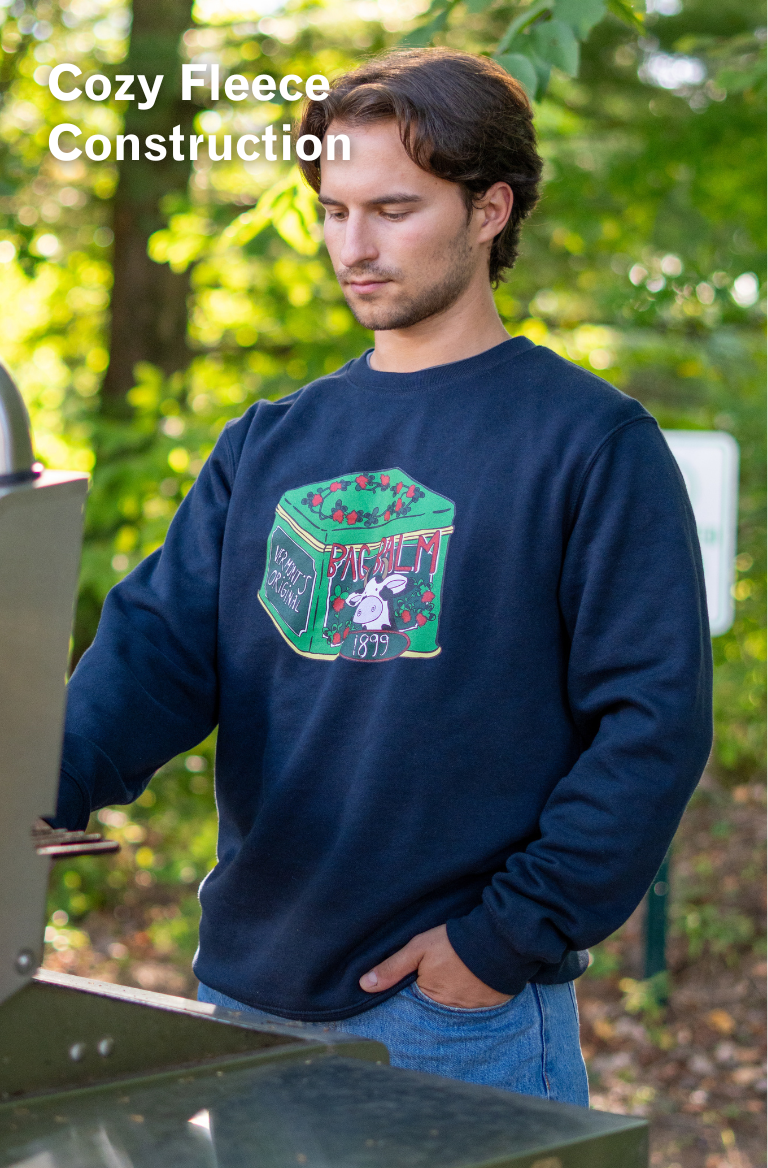 man wearing a crewneck sweatshirt with a cow + tin design