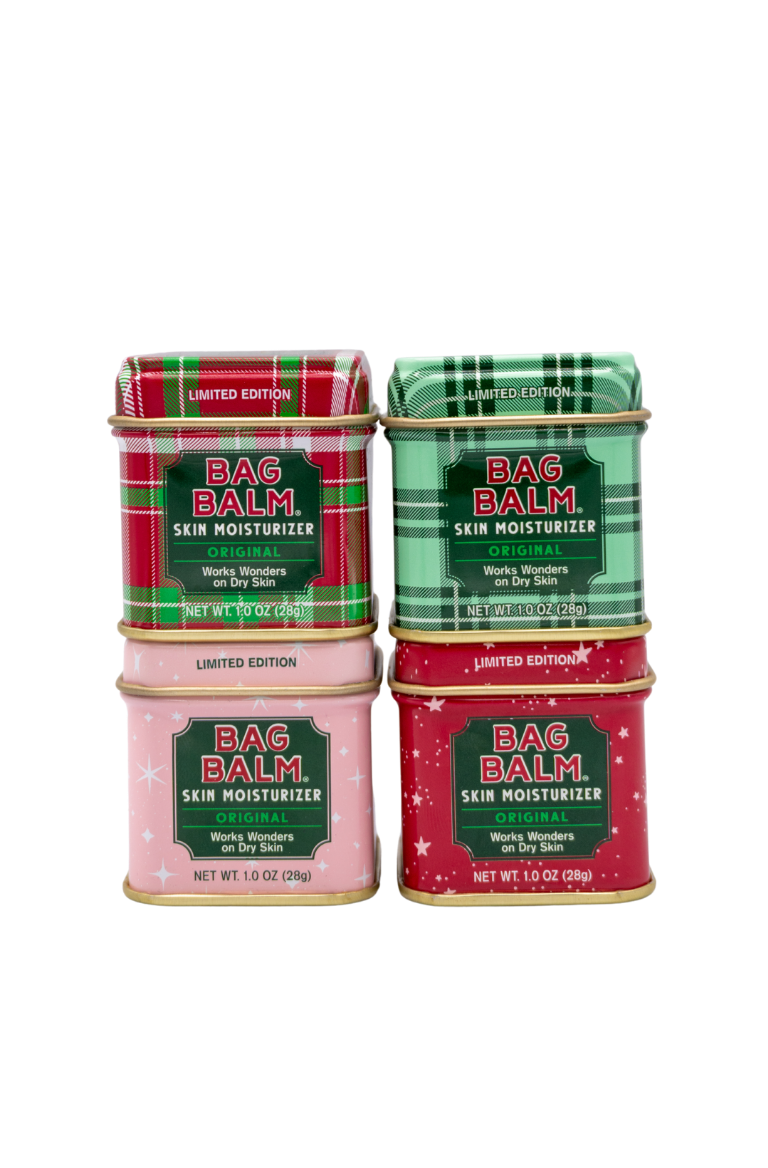 Four containers of Bag Balm skin moisturizer in limited edition tins on a white background.