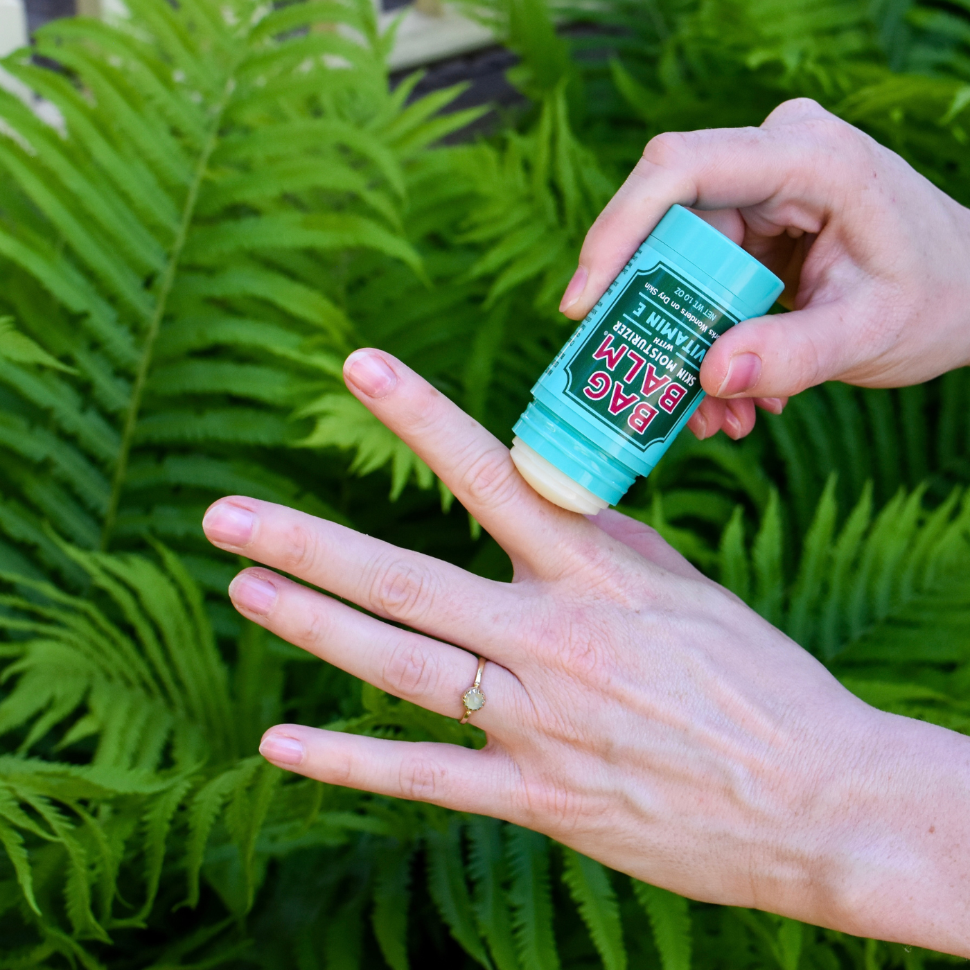 Balm Stick being applied to woman's hand