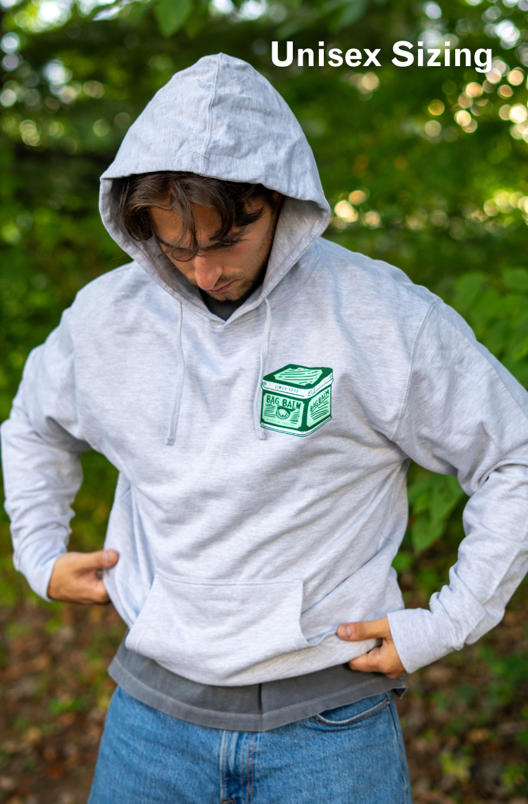 Man wearing a gray hoodie with a vintage tin design
