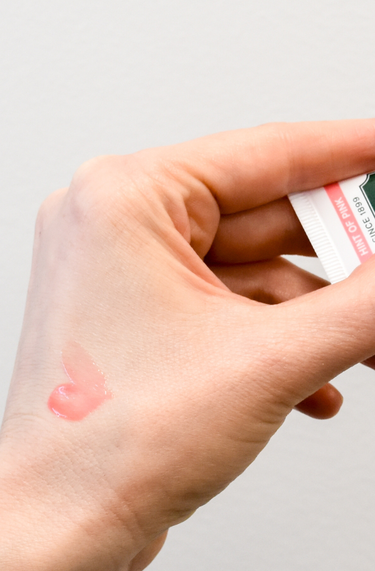 Pink lip balm swatched on hand